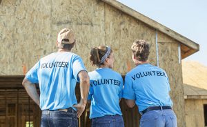 Volunteers helping to build homes for the needy